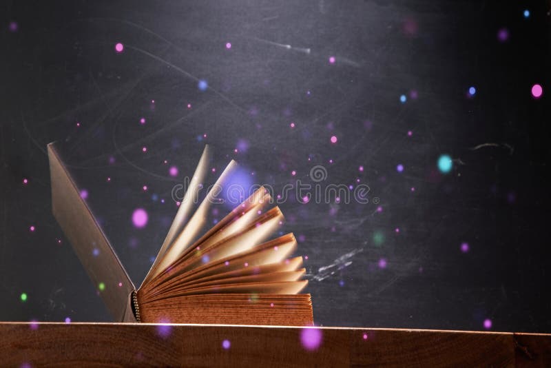 close up of book fanned with magical light
