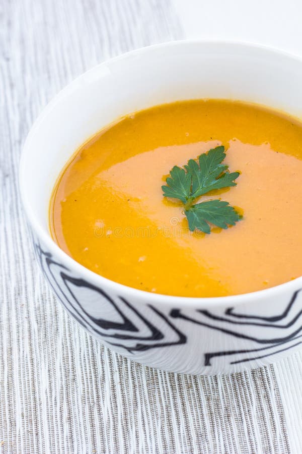 Close up of a bowl of carrot, pumkin and sweet potato soup