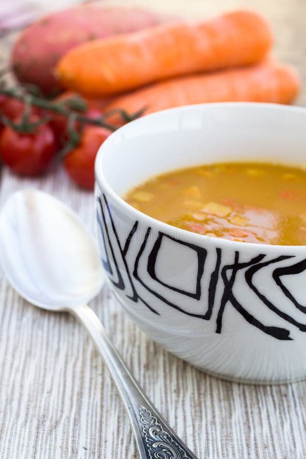 Close up of a bowl of carrot, pumkin and sweet potato soup