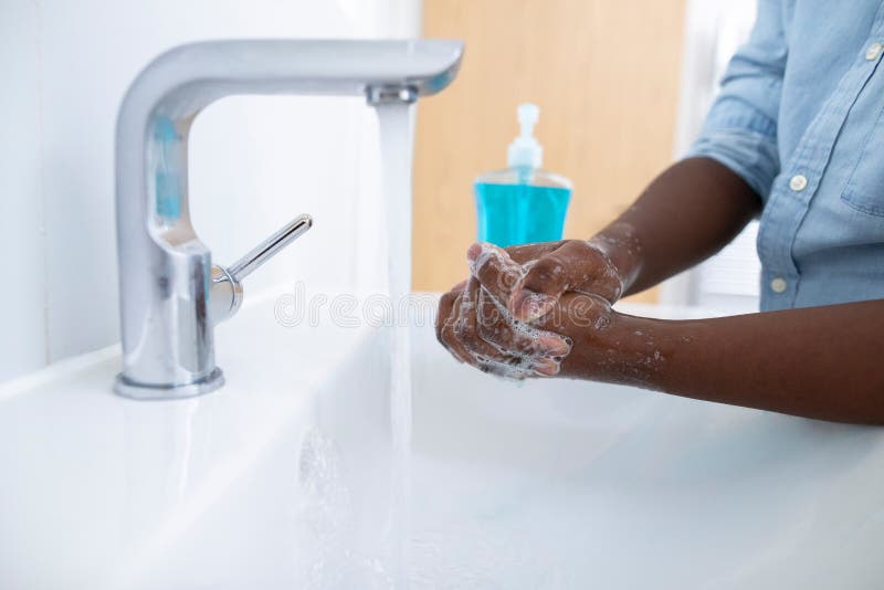 Close Up Of Boy Washing Hands With Soap At Home To Prevent Infection