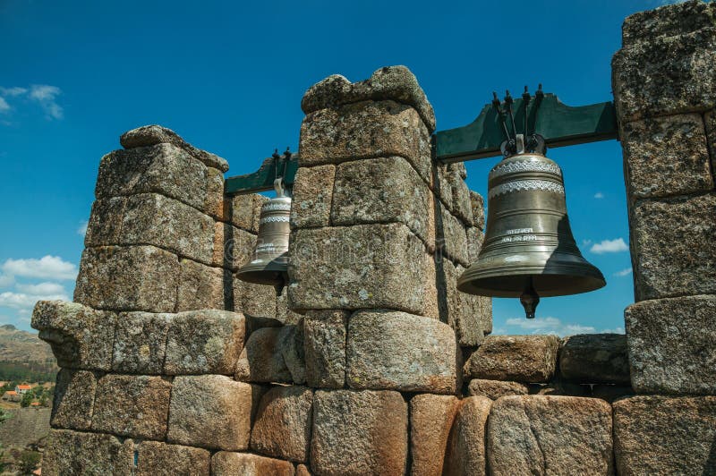 Close-up of bronze bells on top of stone brick wall stock photos Close-up of bronze bells on top of stone brick wall stock photos