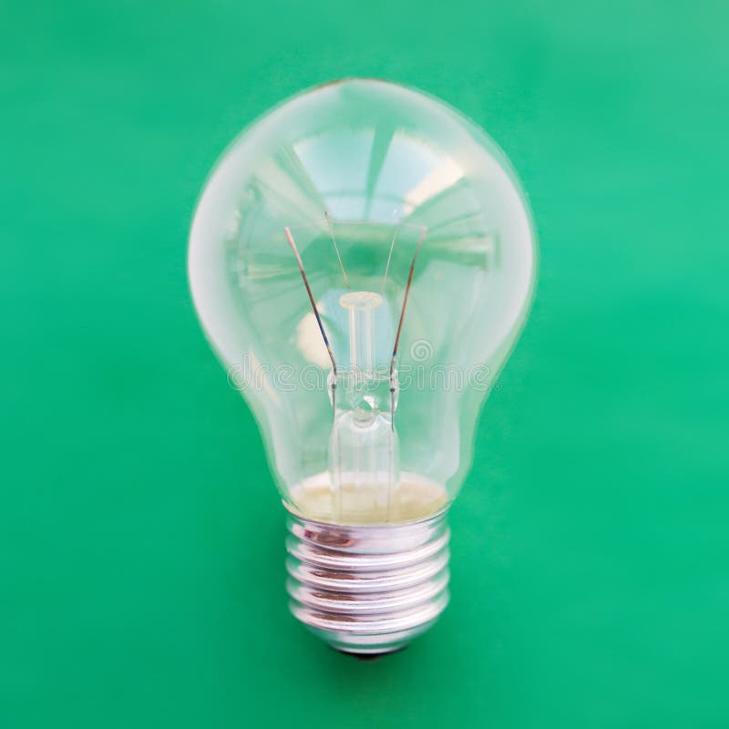 Close up of bulb or incandescent lamp on green stock photos Close up of bulb or incandescent lamp on green stock photos