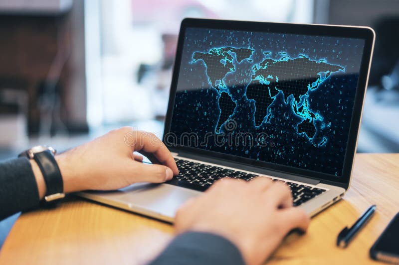 Close up of businessman hands using laptop computer on desktop with glowing binary code map and blurry background. Software and stock photography