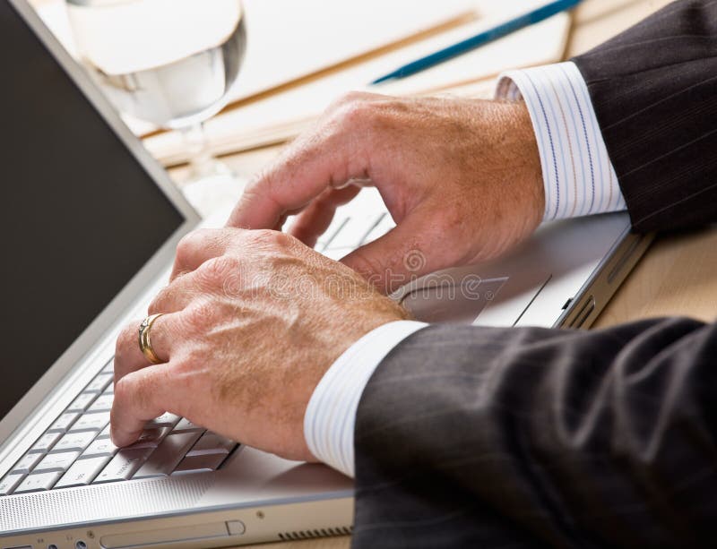 Close up of businessman typing on laptop royalty free stock photos