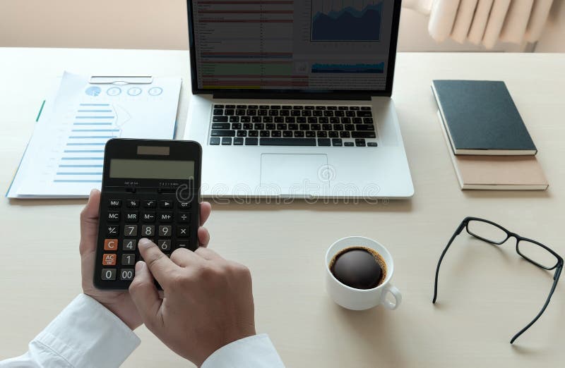 Close Up Businessman Using Calculator on Documents Unrecognizable