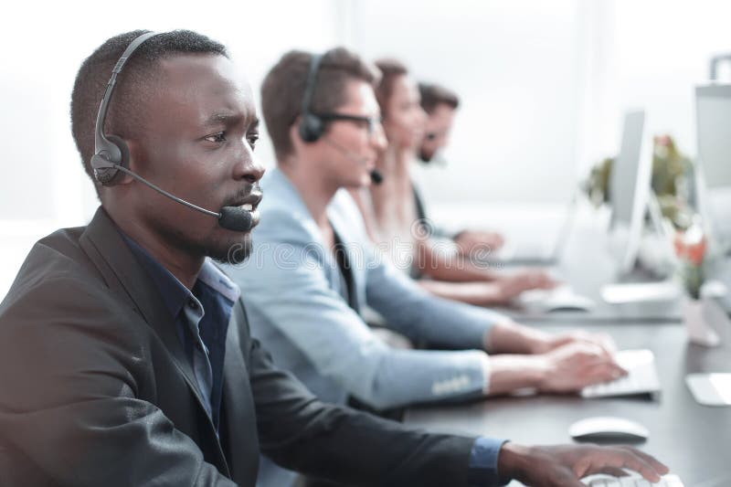 Close up.call center operator on the background of colleagues royalty free stock photos Close up.call center operator on the background of colleagues royalty free stock photos