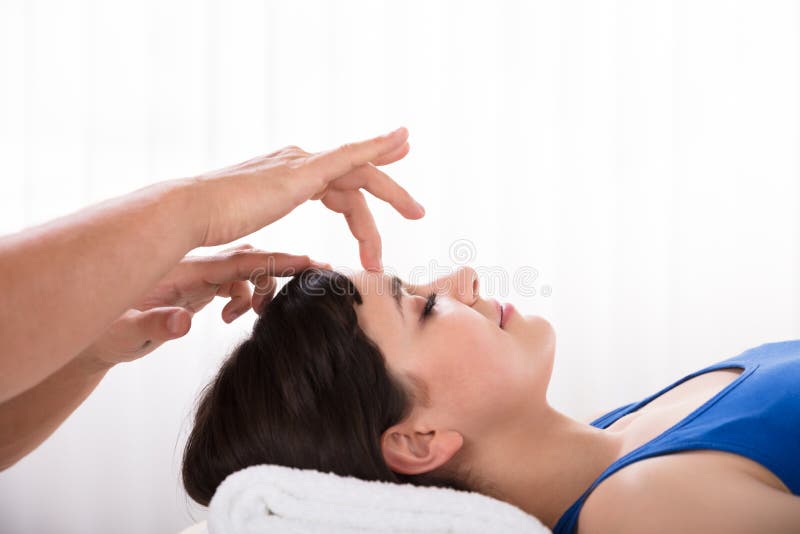 Calm Woman Receiving Reiki Treatment stock photography Calm Woman Receiving Reiki Treatment stock photography