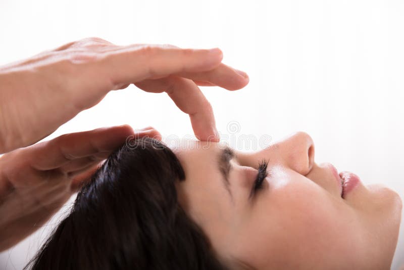 Calm Woman Receiving Reiki Treatment stock image Calm Woman Receiving Reiki Treatment stock image