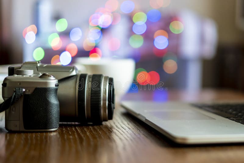 Close Up Camera on the Table of Photographer Workplace with Laptop F