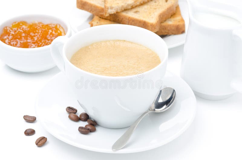 Close-up of cappuccino, milk, fresh toast and jam on white stock photo