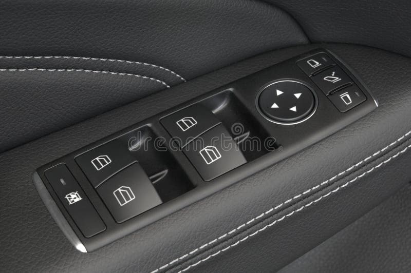 Close up of a car door control panel buttons