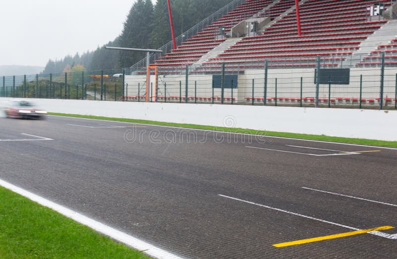 Close up of car driving on speedway track or road