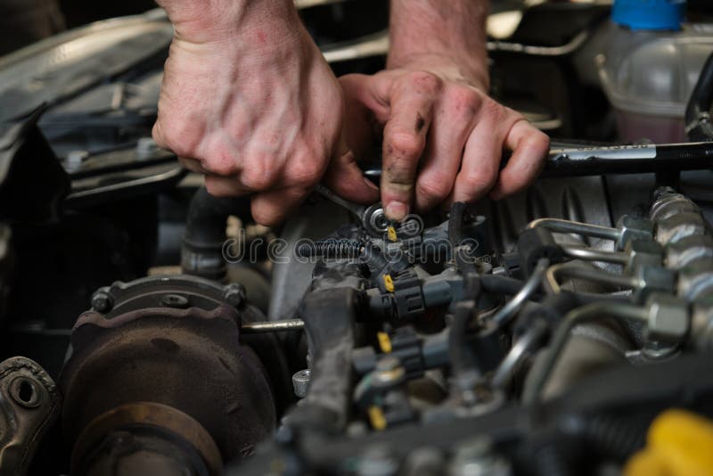 Close Up of Car Mechanic Hands Removing Fuel Injectors. Stock Photo Image of fuel, pressure