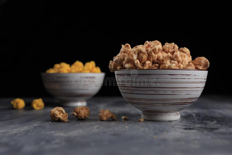 Flavored popcorn in a bowl stock image. Image of confection 168561579