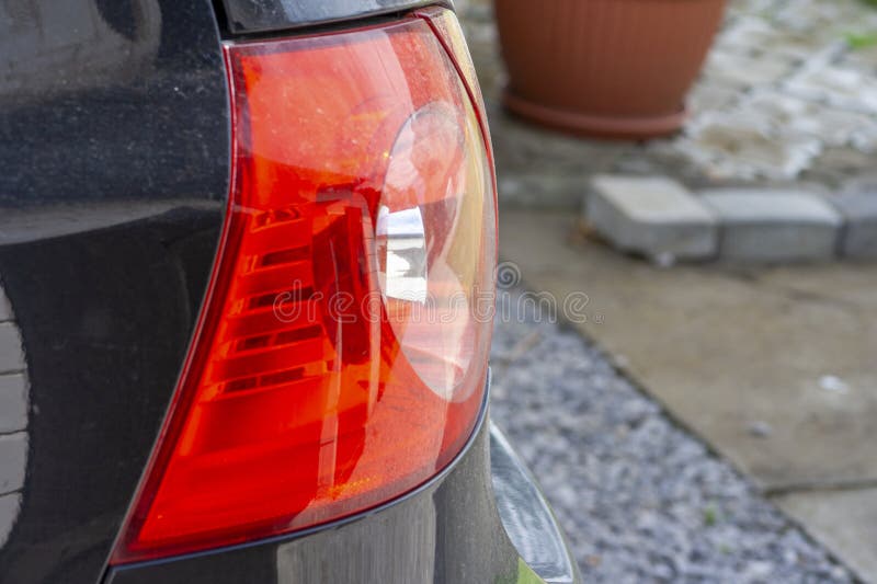 Close-up of a cars taillight showing intricate details and reflections. A vibrant image emphasizing automotive design. stock photo