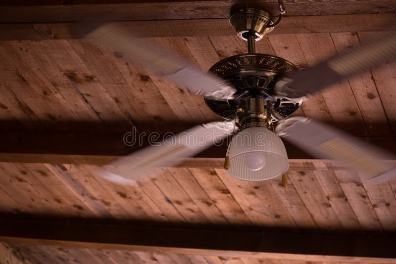 Close Up Of Ceiling Fan Hanged On Wooden Canopy Spinning Stock