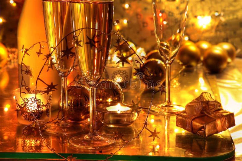 Close-up of champagne,candle on gold background.