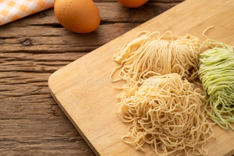 Close Up Chinese Egg Noodle and Jade Noodle on Cutting Board Background