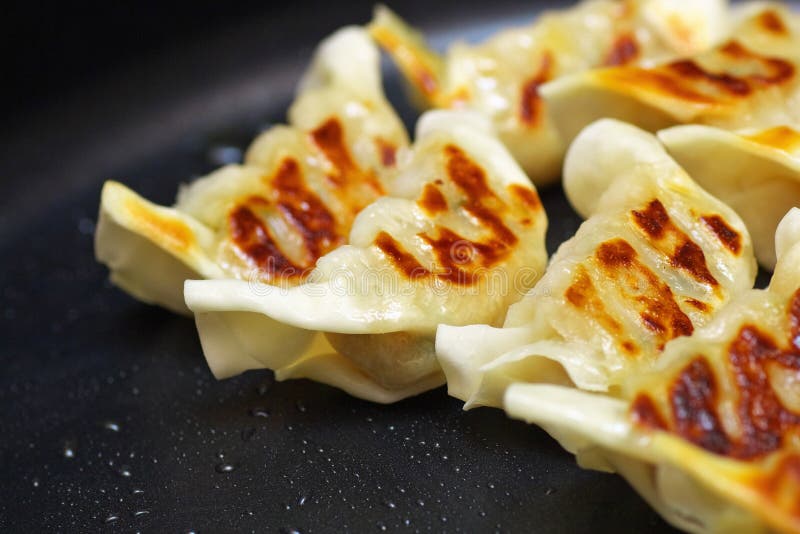 Close up of Chinese fried dumplings on a frying pan. stock images Close up of Chinese fried dumplings on a frying pan. stock images