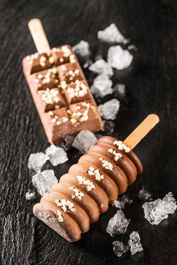 Closeup of Chocolate Ice Cream with Nuts and Ice Cubes Stock Image