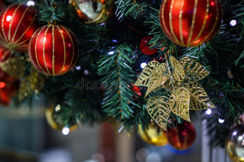 Christmas Tree with Golden Leaves and Shiny Red Ball Ornament Stock ...