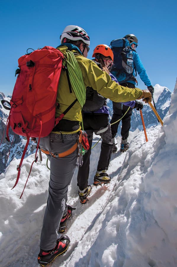 Close-up of climber in french Alps Chamonix Mont Blanc, alpine mountains landscape, clear blue sky in warm sunny summer day. Close-up of climber in french Alps Chamonix Mont Blanc, alpine mountains landscape, clear blue sky in warm sunny summer day