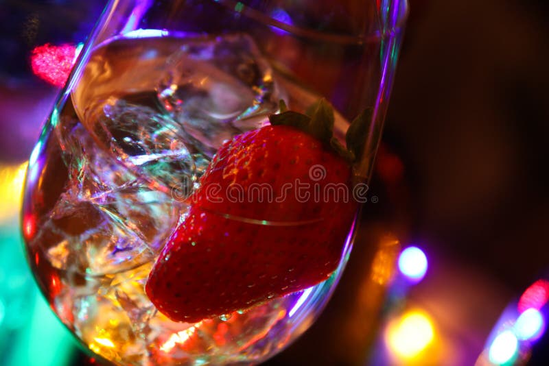 Close up of cocktail with strawberry and ice cubes stock photo Close up of cocktail with strawberry and ice cubes stock photo