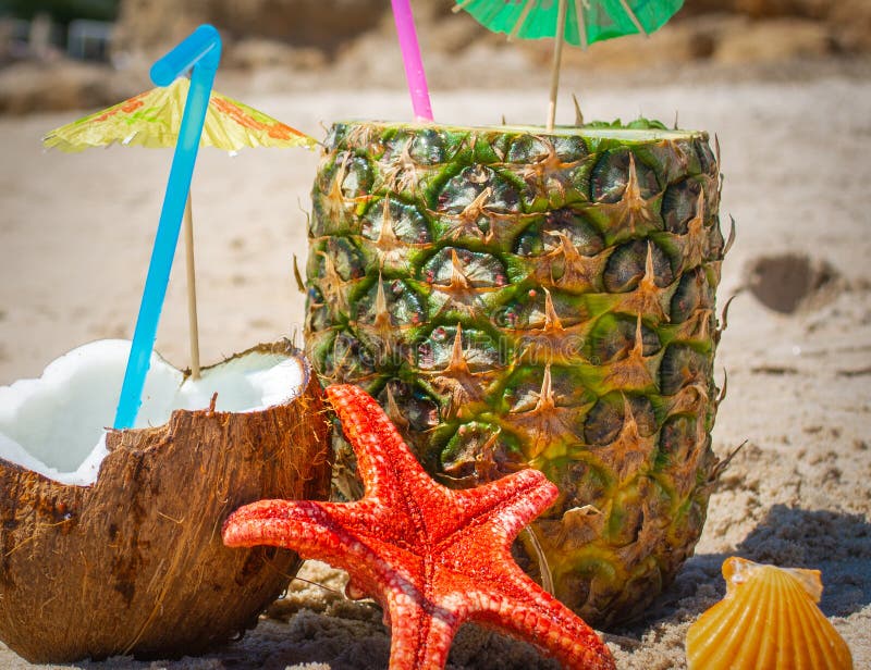 Close Up of Coconut and Pineapple Drinks on the Beach Stock Photo