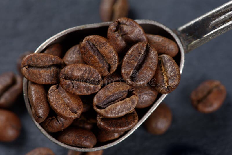 Close up of coffee beans in a spoon