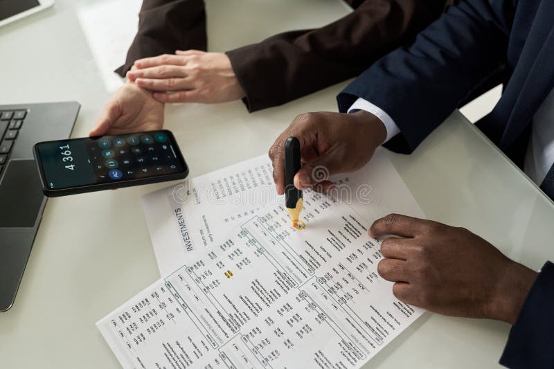 Colleagues Counting Data In Financial Report stock photos