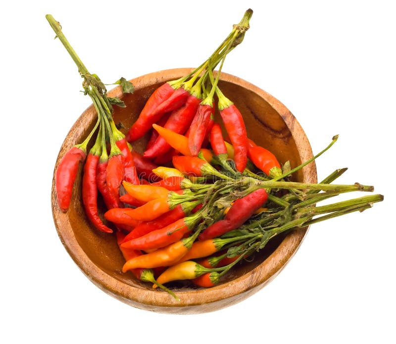 Close-up color wild hot paprika on a wooden plate.