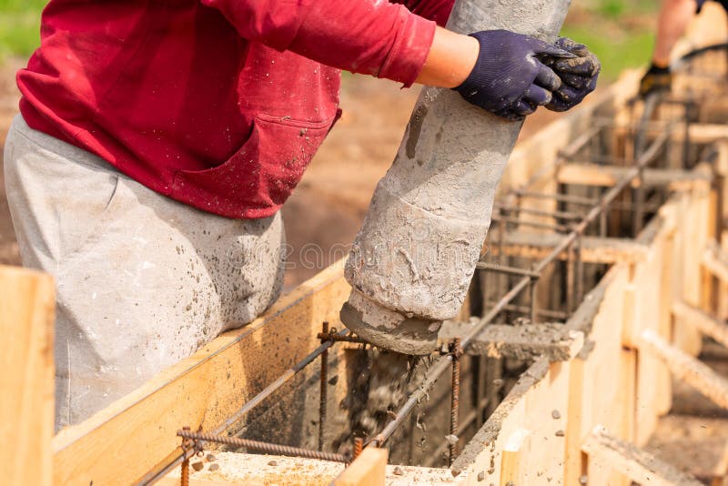 Close Up of Construction Worker Laying Cement or Concrete into the