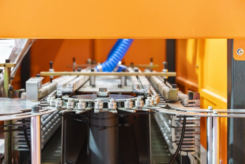 Close Up Continuous Hanging Conveyor Component of Automatic Manufacturing Process Bottle Blowing