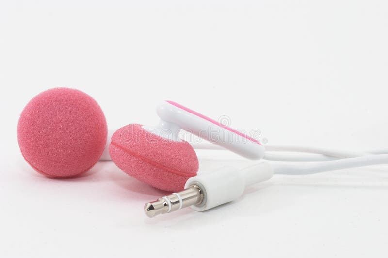 Pink Earbuds Closeup, macro, on white with wires and stereo plug. Pink Earbuds Closeup, macro, on white with wires and stereo plug