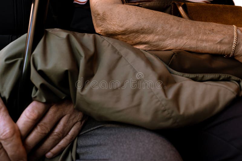 A close-up of a couple of elderly people's arm and hand stock photography