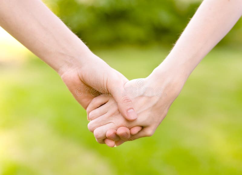 Close up of couple holding hands stock photos