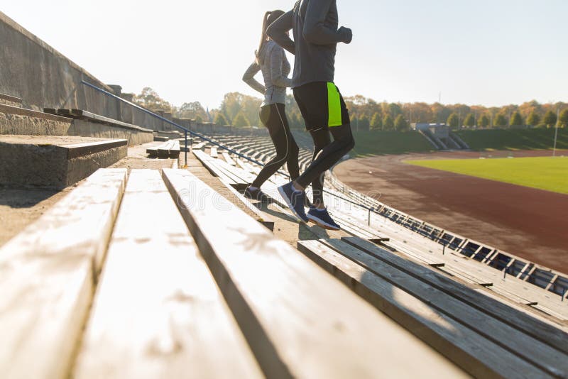 Close Up of Couple Running Downstairs on Stadium Stock Image - Image of ...