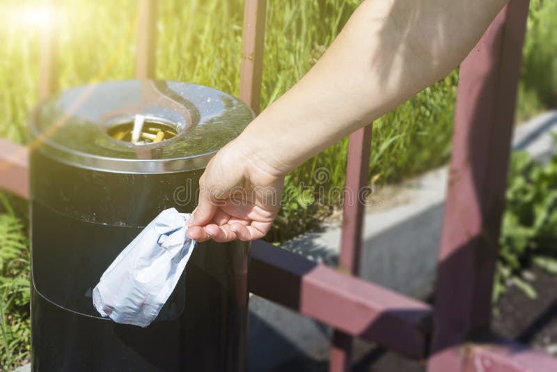 Close Up of Cropped Portrait of Someone Throwing Trash in the Trash