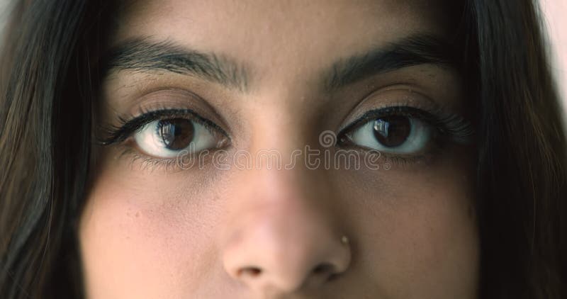 Closeup cropped view happy Indian woman eyes staring at camera