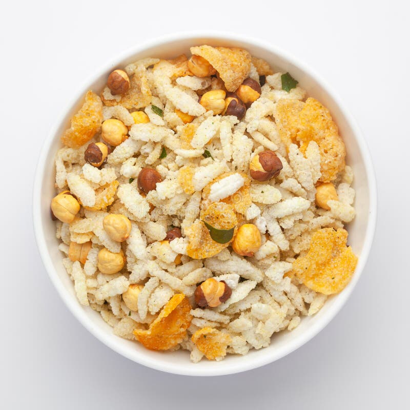 Close-Up of Crunchy Diet Mixture in a white Ceramic bowl made with Puffed Rice, Corn Flakes, and Curry leaves. Indian spicy snacks