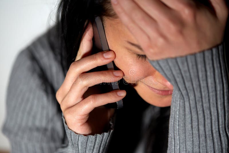 Close up of crying woman calling on smartphone