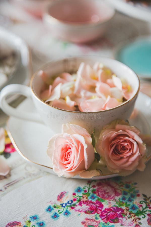 A close up of a cup with tea decorated with roses stock photography A close up of a cup with tea decorated with roses stock photography