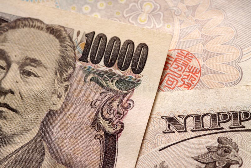 A close-up of the face and number on a 10.000 japanese yen note. A close-up of the face and number on a 10.000 japanese yen note