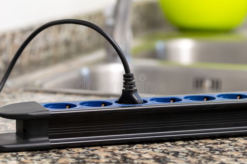 Close up of a dangerous damaged electrical cord a tabletop at kitchen. Damaged extension cord stock images, royalty-free photos and pictures