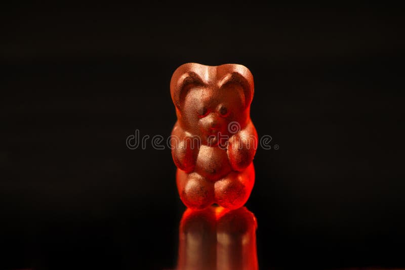 Closeup of a Dark Red Gummy Bear on a Black Background Editorial Stock
