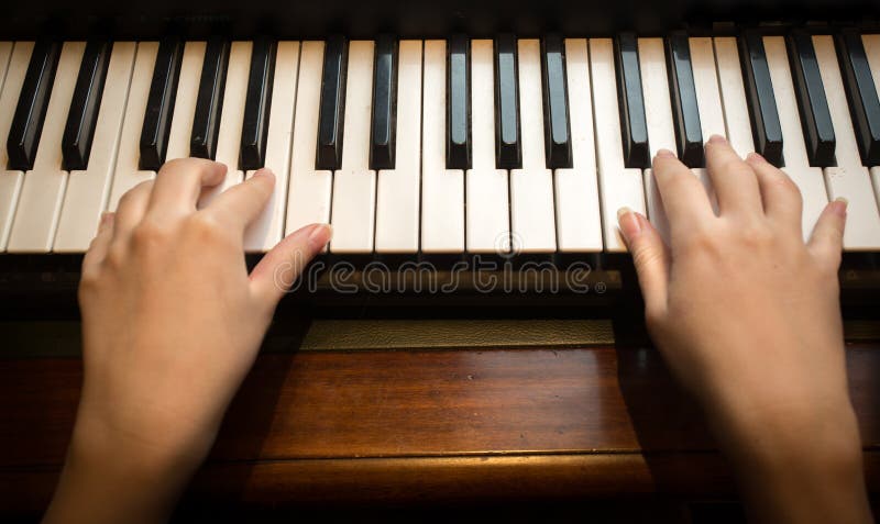Close up das mãos da criança que jogam no piano imagem de stock Close up das mãos da criança que jogam no piano imagem de stock