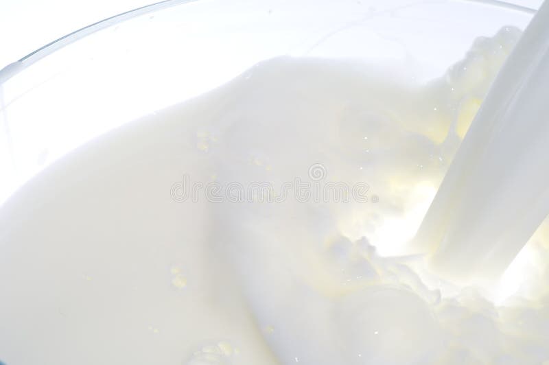 Stream of white fresh pouring milk background. Stream of white fresh pouring milk background