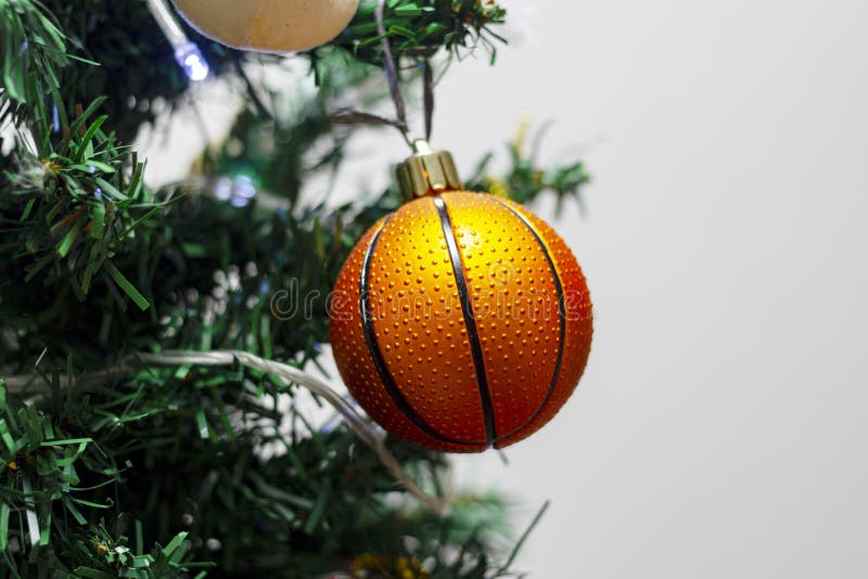 Close Up of Decorations on a Christmas Tree with a Basketball Ball