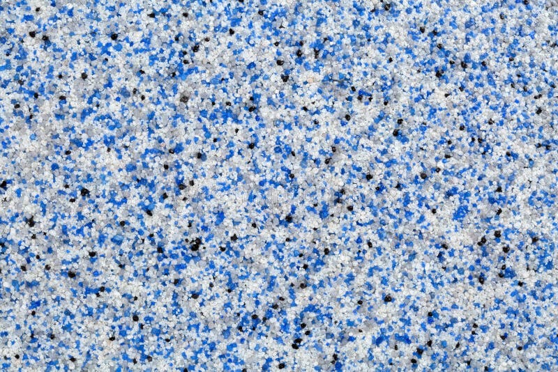 Close up of decorative quartz sand epoxy floor or wall coating with blue, grey, white and black coloured particles