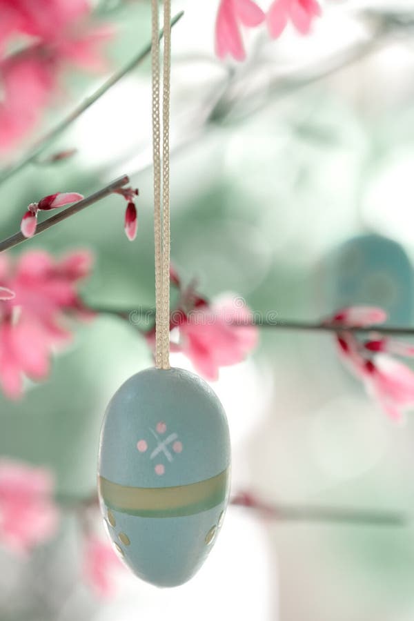 Closeup on Decorative Wooden Easter Eggs Hanging on Stems with Small